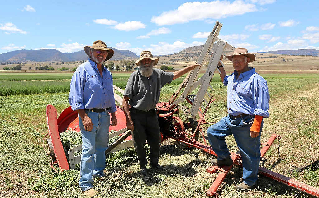 HISTORIC PIECE: Allen Mealy, Mick Bradford and Richard Wheeldon in front of one of the 1880 reaper.
